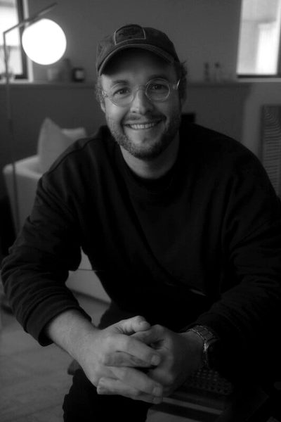 Josh Janssen, documentary filmmaker, in a cap and glasses